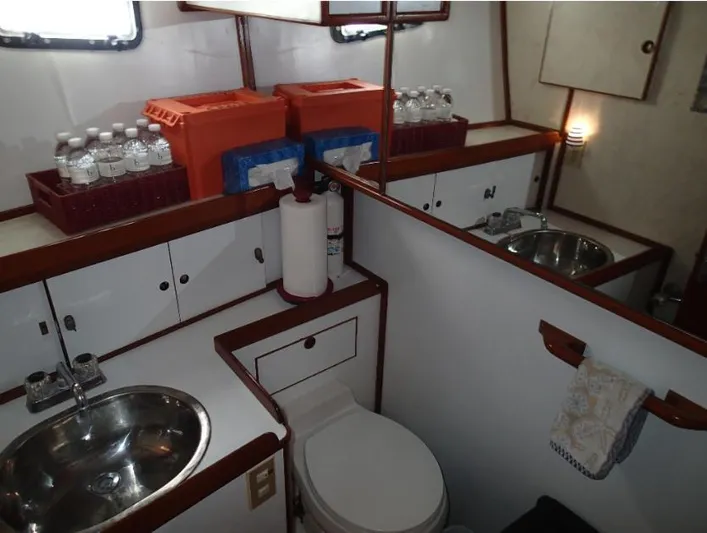 Southern Cross Yacht Photos Pics 1987 Tayana 45 Expedition Trawler bathroom with sink, toilet, and storage.
