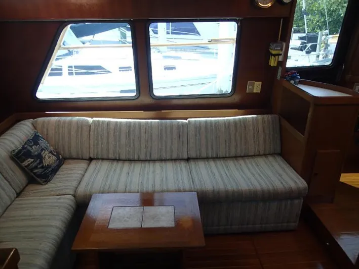 Southern Cross Yacht Photos Pics Interior of 1987 Tayana 45 Expedition Trawler with striped sofa and wooden table.