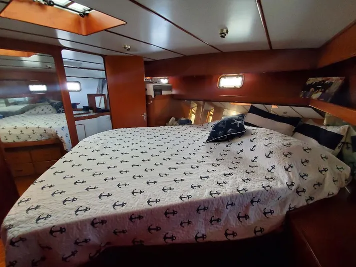 Southern Cross Yacht Photos Pics Cozy bedroom in 1987 Tayana 45 Expedition Trawler with anchor-themed bedding.