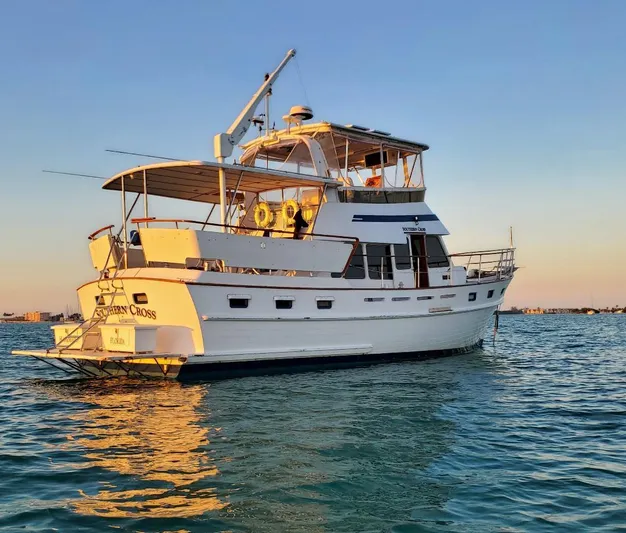 Southern Cross Yacht Photos Pics 1987 Tayana 45 Expedition Trawler on calm water at sunset.