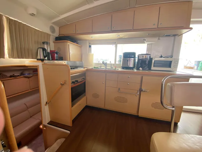  Yacht Photos Pics 2009 Lagoon 440 yacht kitchen with modern appliances and wooden cabinetry.