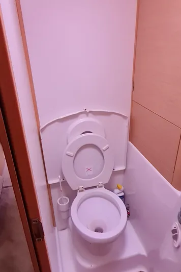  Yacht Photos Pics 2009 Lagoon 440 yacht bathroom with compact toilet and storage space.