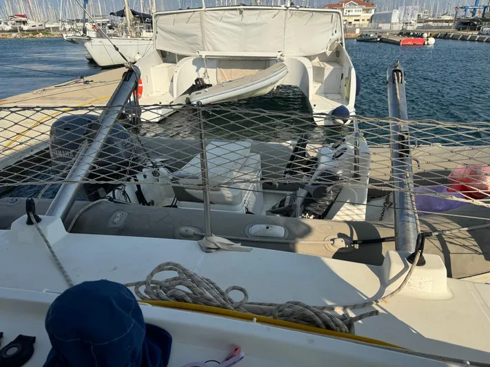  Yacht Photos Pics 2009 Lagoon 440 catamaran docked at marina, featuring netting and ropes on deck.