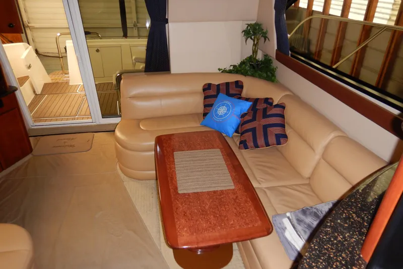 Odyssey Yacht Photos Pics Luxurious interior of 2008 Meridian 411 Sedan with beige leather seating and decorative pillows.