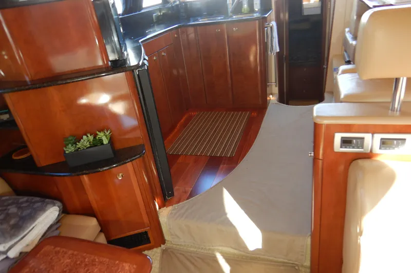 Odyssey Yacht Photos Pics Luxurious interior of a 2008 Meridian 411 Sedan yacht with polished wood cabinetry.