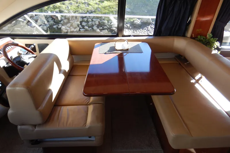 Odyssey Yacht Photos Pics Interior of 2008 Meridian 411 Sedan with elegant dining area and leather seating.