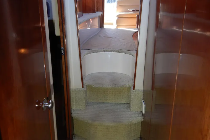 Odyssey Yacht Photos Pics Interior view of 2008 Meridian 411 Sedan yacht with carpeted stairs and wooden paneling.