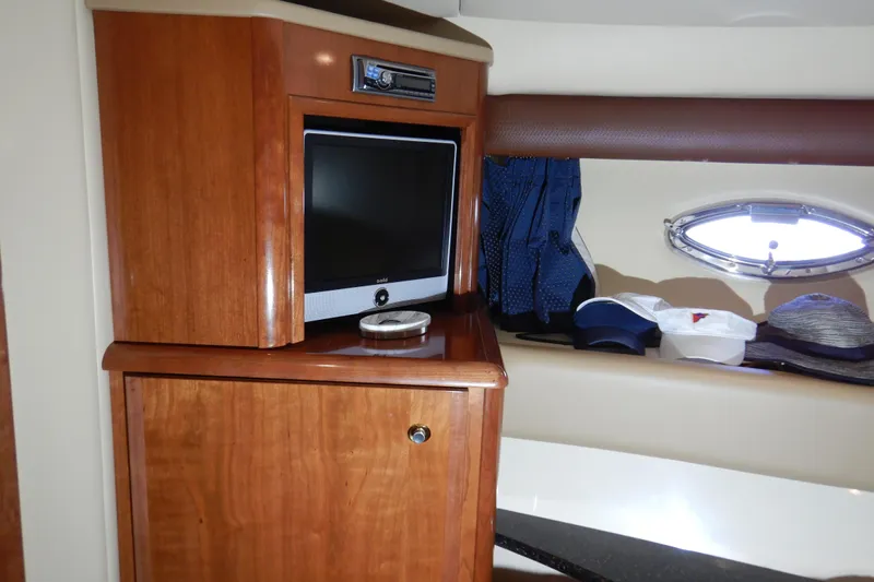Odyssey Yacht Photos Pics Interior of 2008 Meridian 411 Sedan with TV and wooden cabinetry.