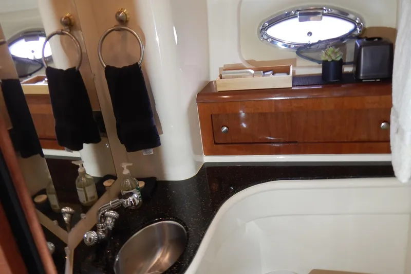Odyssey Yacht Photos Pics Luxurious bathroom interior of 2008 Meridian 411 Sedan yacht with sink and wooden cabinetry.