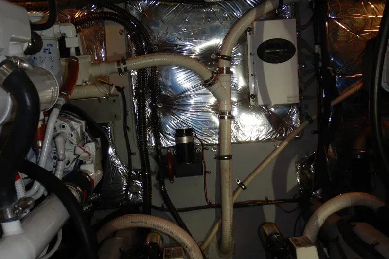 Odyssey Yacht Photos Pics Engine room of a 2008 Meridian 411 Sedan with visible pipes and insulation.