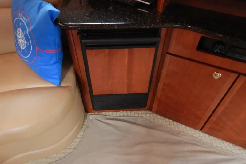 Odyssey Yacht Photos Pics Interior of 2008 Meridian 411 Sedan with wood cabinetry and blue cushion.