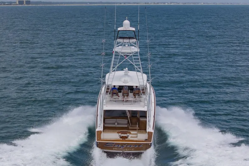 Safari Yacht Photos Pics 2022 Viking 72 Convertible yacht cruising on open water, rear view.