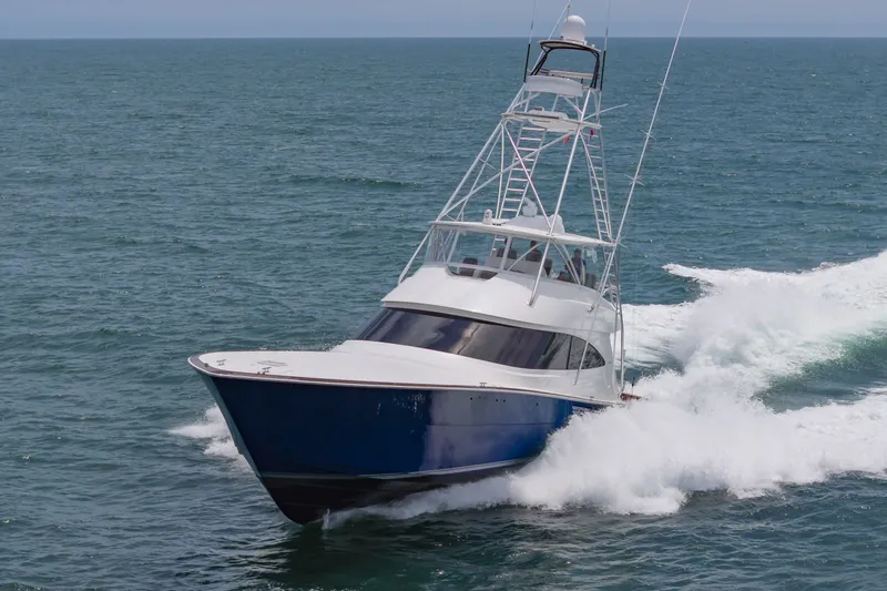 Safari Yacht Photos Pics 2022 Viking 72 Convertible yacht cruising on open sea, creating waves.