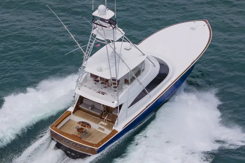 Safari Yacht Photos Pics 2022 Viking 72 Convertible yacht cruising on open water, aerial view.