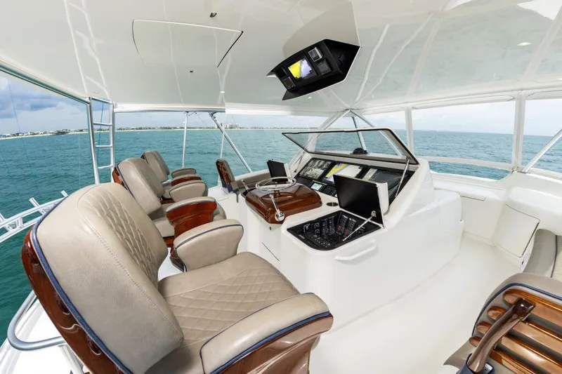 Safari Yacht Photos Pics Luxurious helm of 2022 Viking 72 Convertible yacht with leather seats and advanced navigation systems.