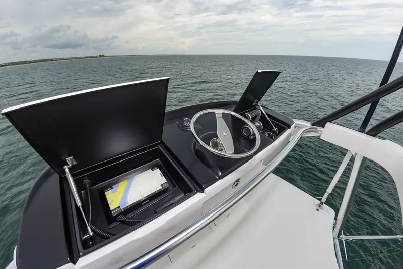 Safari Yacht Photos Pics Helm of 2022 Viking 72 Convertible yacht with navigation screens, steering wheel, and ocean view.