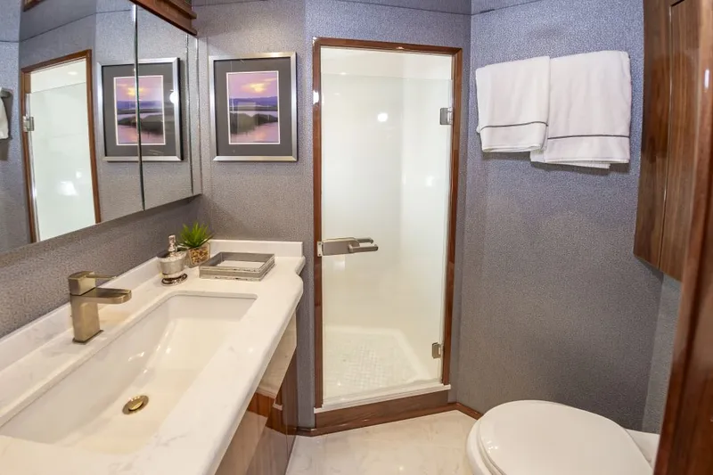 Safari Yacht Photos Pics Luxurious bathroom in 2022 Viking 72 Convertible yacht with modern fixtures and elegant decor.