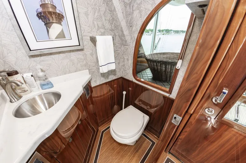 Safari Yacht Photos Pics Luxurious bathroom in 2022 Viking 72 Convertible yacht with wood accents and modern fixtures.
