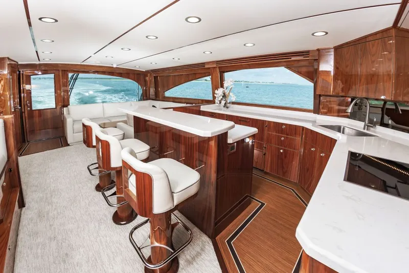 Safari Yacht Photos Pics Luxurious interior of 2022 Viking 72 Convertible yacht with elegant wood finishes and ocean view.
