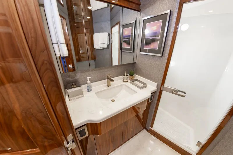 Safari Yacht Photos Pics Luxurious bathroom in 2022 Viking 72 Convertible yacht with elegant wood finishes.