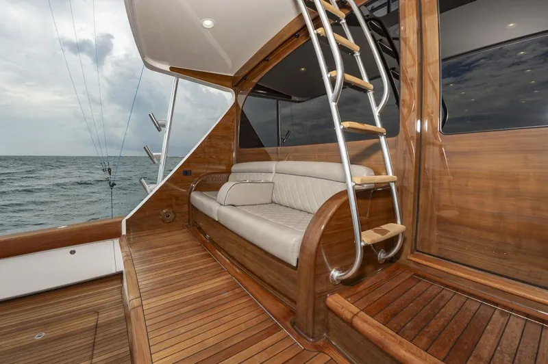 Safari Yacht Photos Pics Luxurious 2022 Viking 72 Convertible yacht interior with wooden deck and seating.