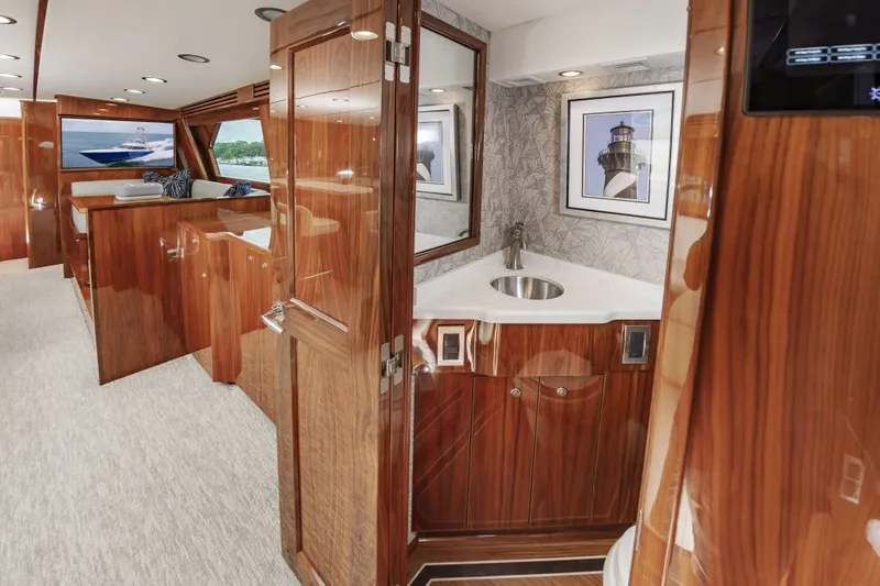 Safari Yacht Photos Pics Luxurious interior of 2022 Viking 72 Convertible yacht with wood finishes and modern amenities.