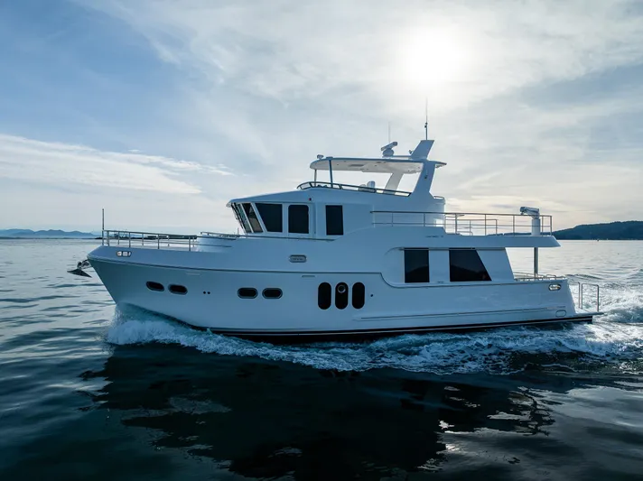 Oasis Yacht Photos Pics 2024 Northwest 55 yacht cruising on calm waters under a bright sky.