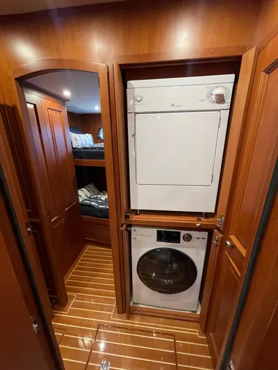 Oasis Yacht Photos Pics Laundry area with stacked washer and dryer in 2024 Northwest 55 yacht interior.