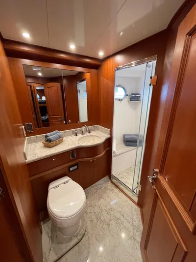Oasis Yacht Photos Pics Luxurious bathroom in 2024 Northwest 55 yacht with wood accents and modern fixtures.