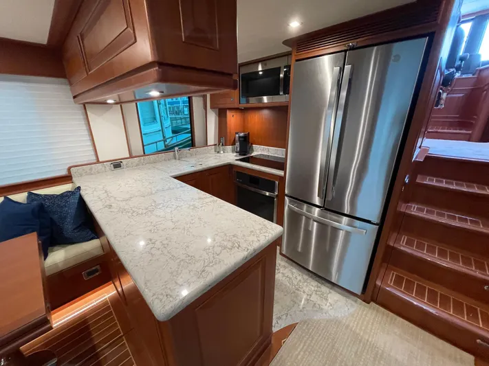 Oasis Yacht Photos Pics Luxurious kitchen in 2024 Northwest 55 yacht with modern appliances and elegant wood finishes.