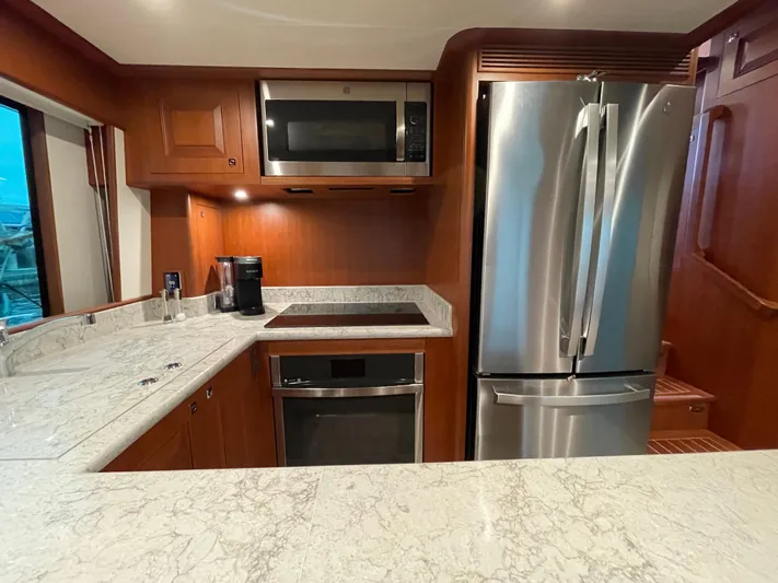Oasis Yacht Photos Pics Modern kitchen in 2024 Northwest 55 yacht with stainless steel appliances and marble countertops.