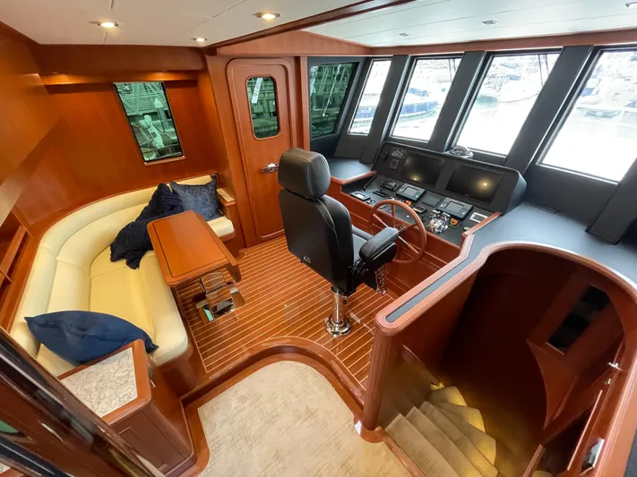 Oasis Yacht Photos Pics Luxurious 2024 Northwest 55 yacht interior with helm, seating area, and wood finishes.