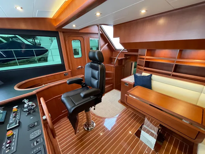Oasis Yacht Photos Pics Luxurious 2024 Northwest 55 yacht interior with leather captain's chair and elegant wood finish.