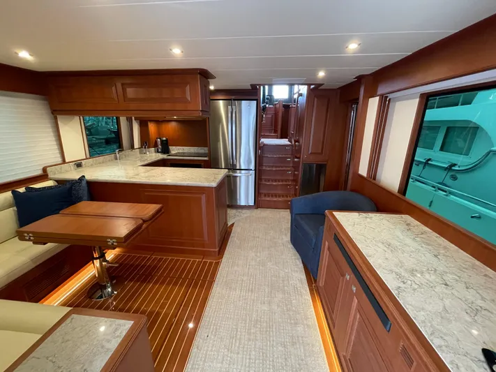 Oasis Yacht Photos Pics Luxurious interior of 2024 Northwest 55 yacht with modern kitchen and elegant wood finishes.