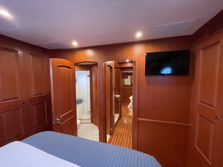 Oasis Yacht Photos Pics Luxurious cabin interior of 2024 Northwest 55 yacht with wood paneling and modern amenities.