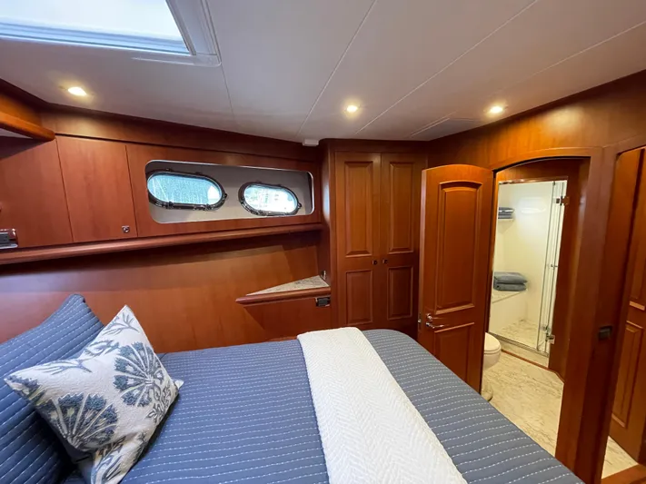 Oasis Yacht Photos Pics Luxurious cabin interior of 2024 Northwest 55 yacht with wood finish and ensuite bathroom.