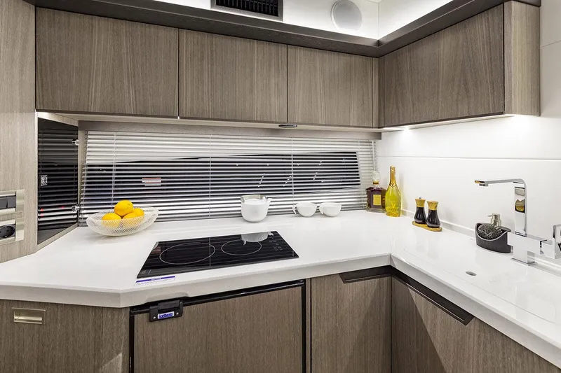  Yacht Photos Pics Manufacturer Provided Image: Modern kitchen in 2021 Galeon 425 HTS yacht with sleek countertops and appliances.