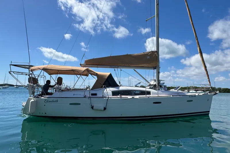  Yacht Photos Pics 2008 Beneteau Oceanis 40 sailboat on calm water under a clear blue sky.