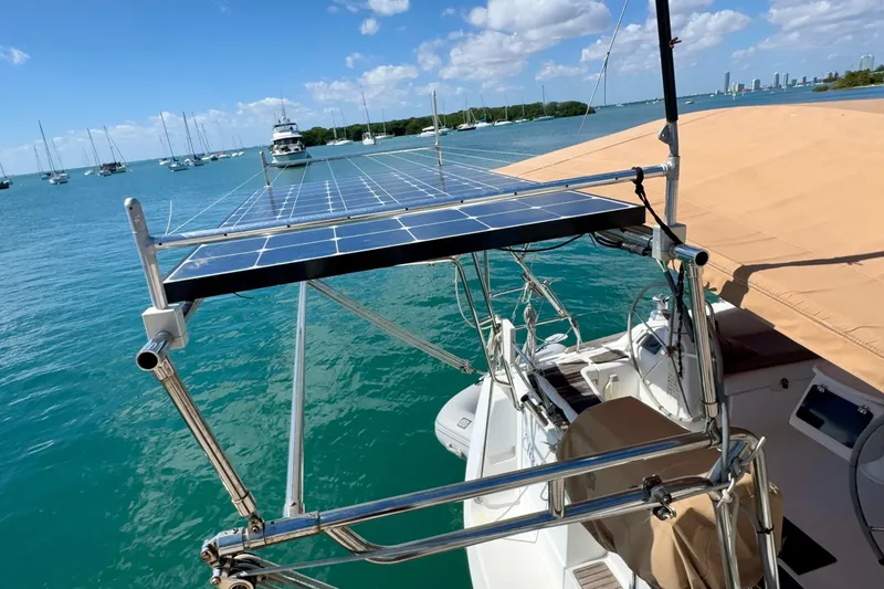  Yacht Photos Pics 2008 Beneteau Oceanis 40 sailboat with solar panels on deck, anchored in a marina.