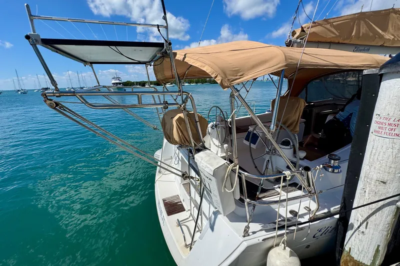  Yacht Photos Pics Beneteau Oceanis 40 sailboat docked, featuring tan canopy and clear blue water, 2008 model.