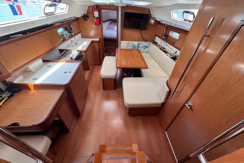 Yacht Photos Pics Interior of 2008 Beneteau Oceanis 40 sailboat with wood finish and cozy seating area.