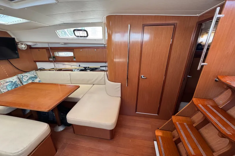  Yacht Photos Pics Interior of 2008 Beneteau Oceanis 40 yacht with wooden finishes and cozy seating area.