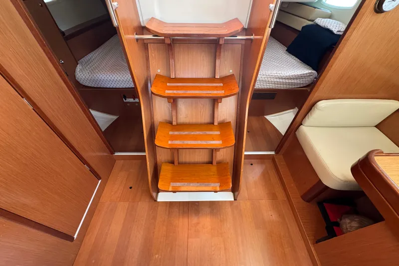  Yacht Photos Pics Interior of 2008 Beneteau Oceanis 40 sailboat with wooden steps and cozy cabin layout.