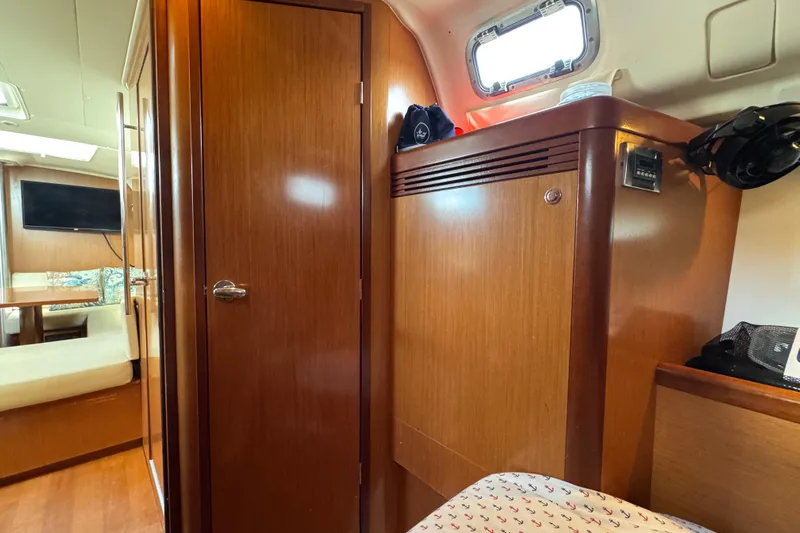  Yacht Photos Pics Interior of 2008 Beneteau Oceanis 40 yacht, featuring wooden cabinetry and seating area.