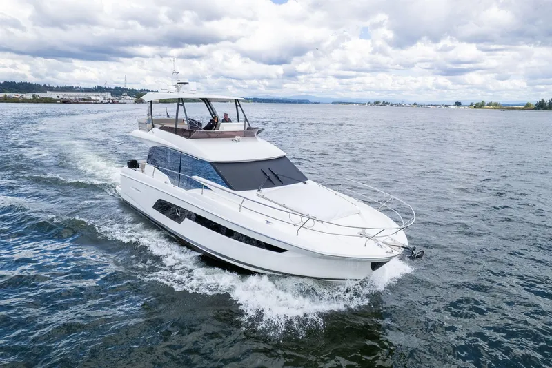  Yacht Photos Pics 2022 Prestige 520 yacht cruising on open water under cloudy skies.