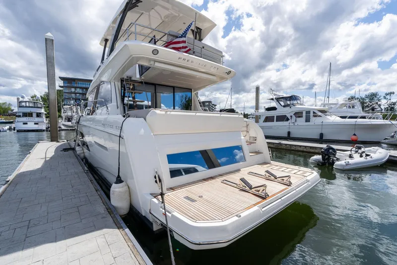  Yacht Photos Pics Luxury 2022 Prestige 520 yacht docked at marina under cloudy sky.