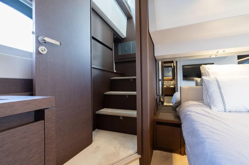  Yacht Photos Pics Luxurious interior of 2022 Prestige 520 yacht with modern bedroom and staircase.