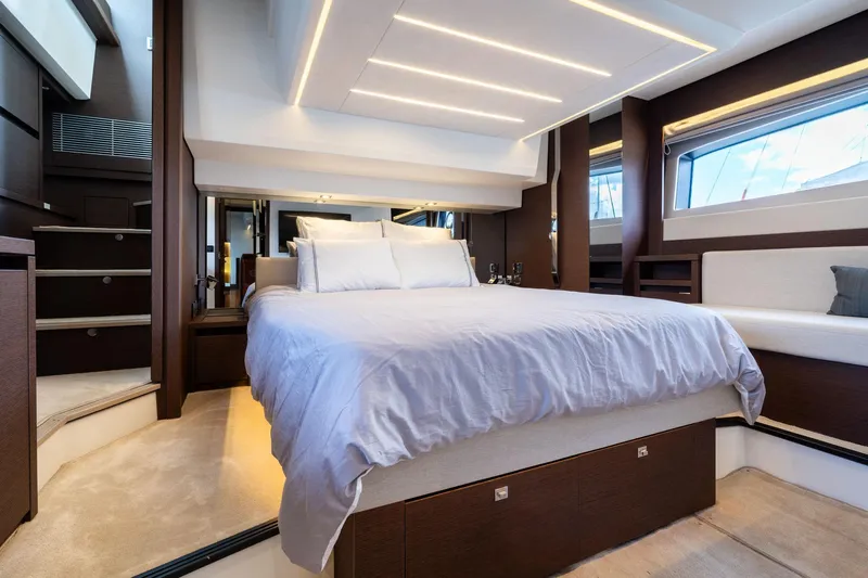  Yacht Photos Pics Luxurious bedroom interior of 2022 Prestige 520 yacht with modern design and ambient lighting.