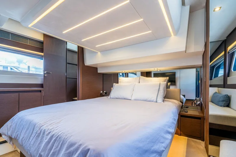  Yacht Photos Pics Luxurious bedroom interior of 2022 Prestige 520 yacht with modern lighting and elegant design.