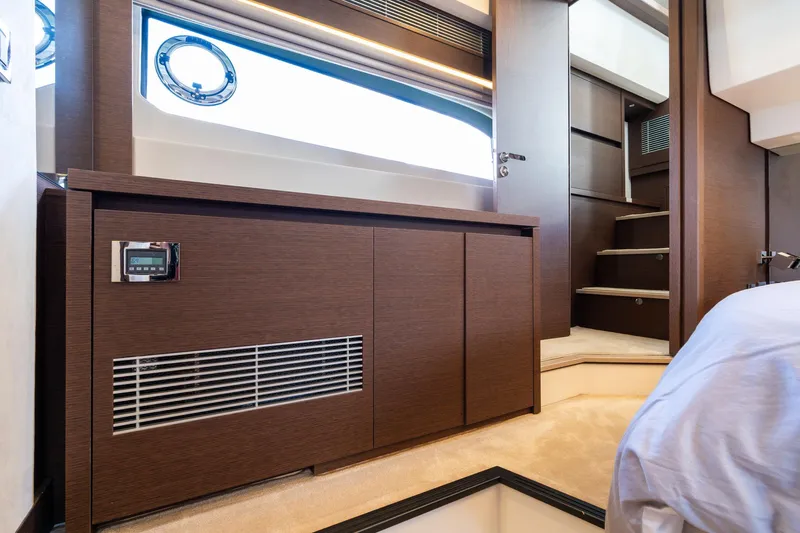  Yacht Photos Pics Luxurious interior of 2022 Prestige 520 yacht with modern wood finish and elegant staircase.